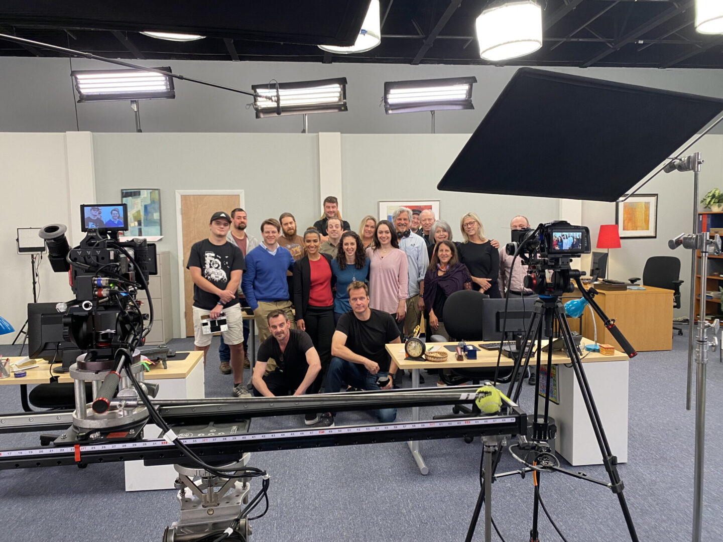 A group of people posing for a picture in front of a camera.